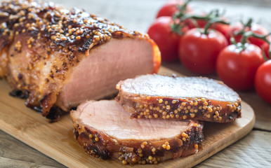 Baked pork meat wrapped in bacon