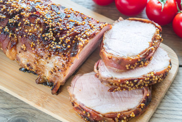 Baked pork meat wrapped in bacon