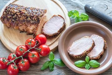 Baked pork meat wrapped in bacon