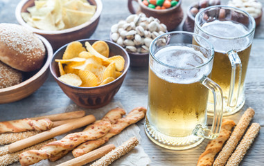 Two glasses of beer with appetizers