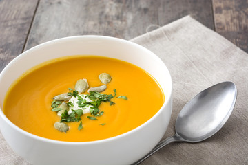 Pumpkin soup in bowl and pumpkin seeds

