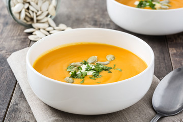 Pumpkin soup in bowl and pumpkin seeds

