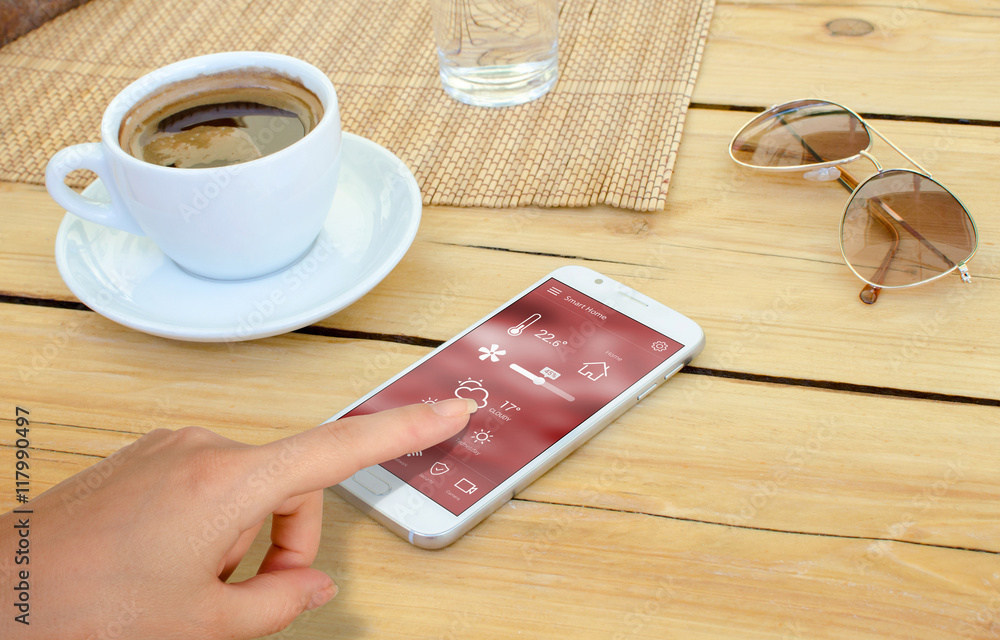 Poster home control control temperature, safety and environment with mobile app. smart phone on table, coff