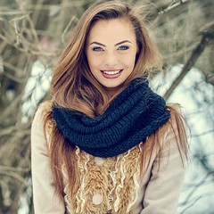 Beautiful young woman in winter park