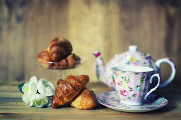 tea cup croissant breakfast
