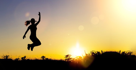 Obraz na płótnie Canvas Website banner of a happy female silhouette at sunset