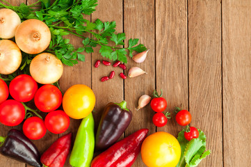 Tomatoes, peppers, onions on a wooden table
