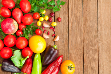 Tomatoes, peppers, apples on a wooden table