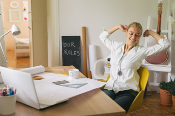 Its time for break. Young college student stretching while studying