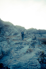 man walking on rocks, summer holidays