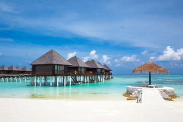 beach with water bungalows at Maldives