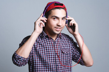 male teenager with headphones in the studio, the concept of musi