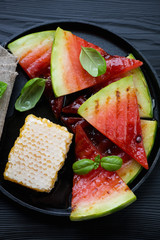 Above view of a frying pan with grilled watermelon and honey