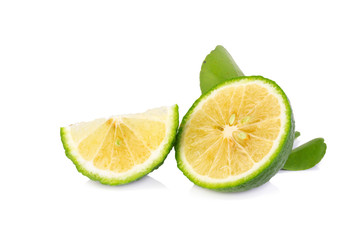 Limes with slices and leaves isolated on white background