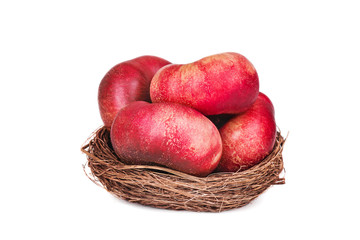 a basket of flat nectarines on white backgraund