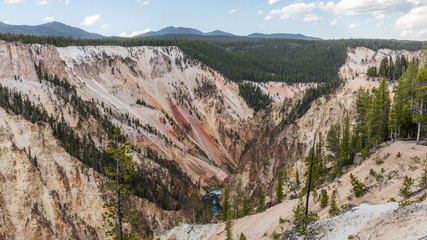 Stormy river flows in a narrow gorge in the rocks. Mountain landscape. Uncle Toms Trail on The Grand Canyon of the Yellowstone National Park, Wyoming