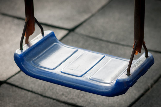 blue plastic  swing at playground.