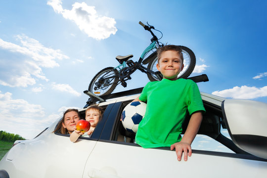 Happy Sporty Family Travelling By Car In Summer