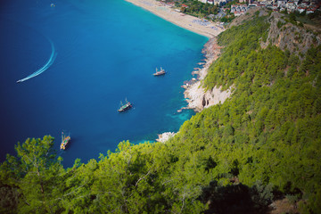 Obraz premium yachts float in a quiet comfortable blue lagoon among the mountains of turkey