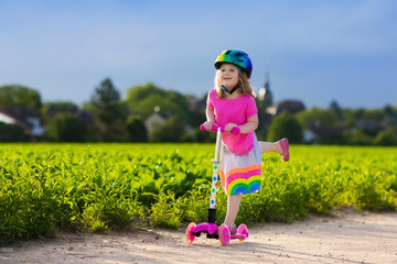 Little girl on a scooter