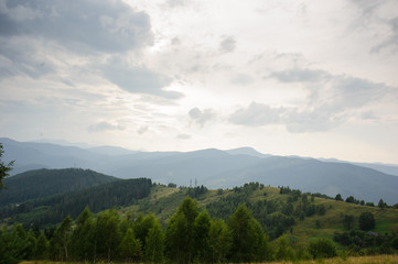 Fototapeta premium Summer landscape in mountains and the dark blue sky with clouds