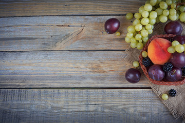 Mix of fresh berries and fruits on rustic wooden background