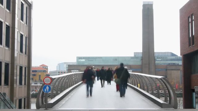 people crossing the millenium bridge