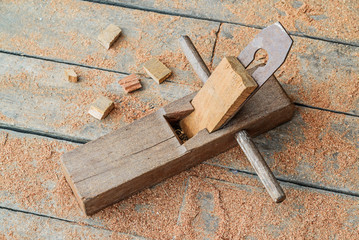 Old wooden carpenter hand plane on wooden.