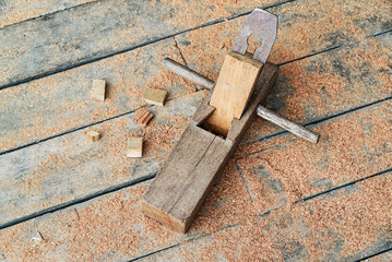 Old wooden carpenter hand plane on wooden.