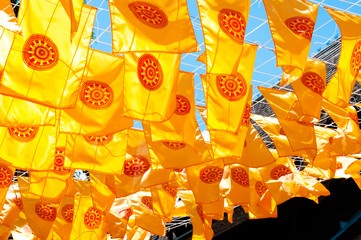 Thammachak flag yellow in temple (Wat Phan tao) on blue sky temple Northern Thailand
