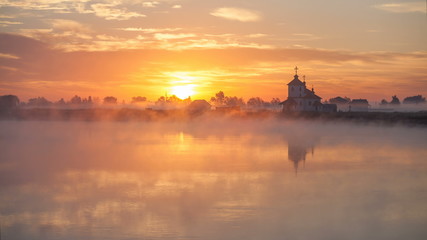 sunrise on the river near the church