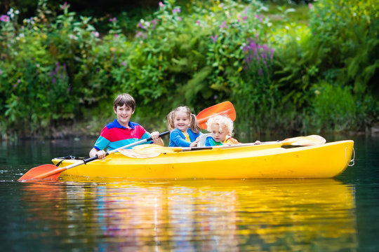 Kids kayaking on a river