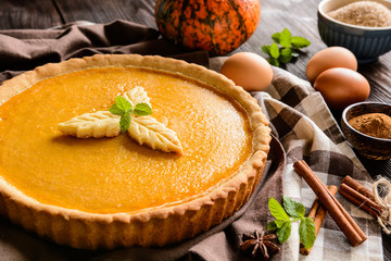 Traditional American pumpkin pie with cinnamon and mint