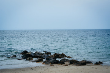 Fototapeta na wymiar Rocks in the Atlantic Ocean at Town Beach, in Sandwich, Cape Cod