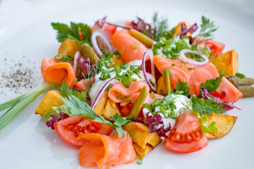 salad with fish and tomato, with greens