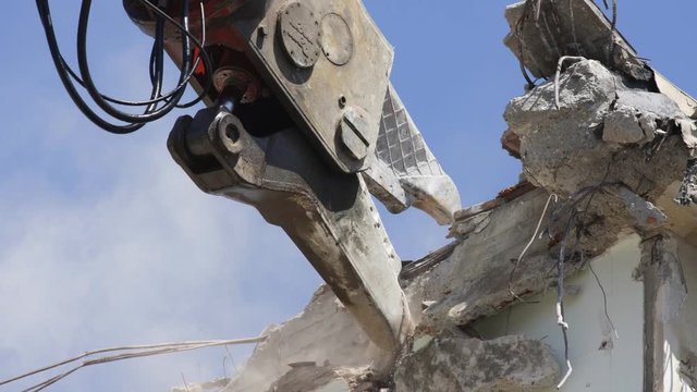 a crane breaking down a building