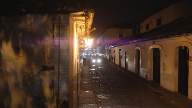 Empty streets of colonial town illuminated with warm lanterns Giron, Colombia