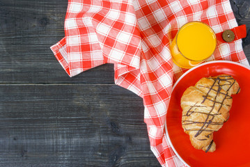 Background: white textured surface of the table, a tablecloth on it in red cell and big round...