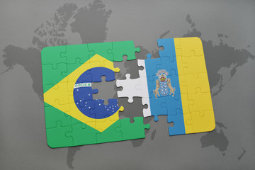puzzle with the national flag of brazil and canary islands on a world map background.