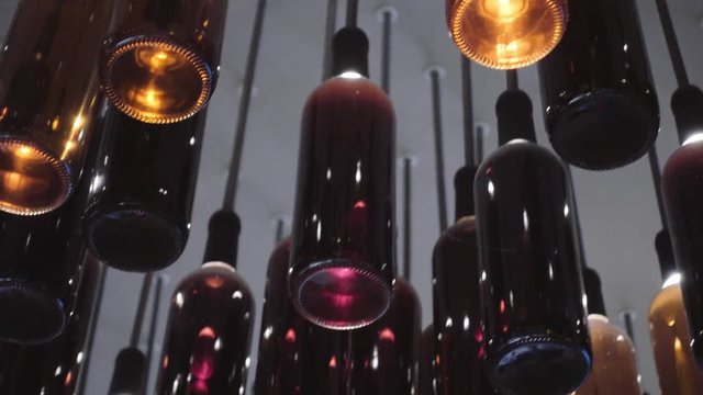 Colorful bottles hanging on the ceiling as decoration. 4k