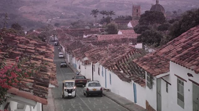People passing on street of touristic town in Barichara, Colombia. 4k