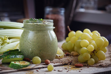 Fresh organic green smoothie with cucumber, parsley, grapes and