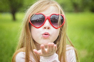 Adorable little girl in the forest meadow