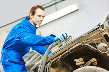 auto mechanic polishing car
