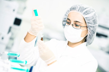 Scientific researcher pouring flask with liquid solution