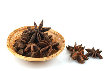 Star Anise, spices, medicinal properties in a basket on a white background.