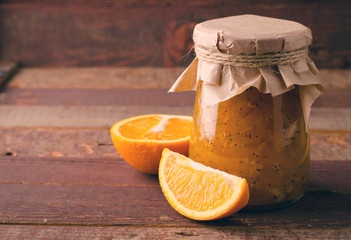 Pumpkin-Orange-Ginger-Poppy seed jam on wooden background.