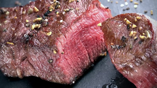 Beef Fillet (grilled; not loopable; 4K) on wooden background