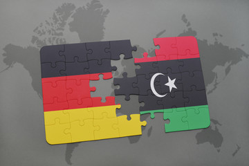 puzzle with the national flag of germany and libya on a world map background.