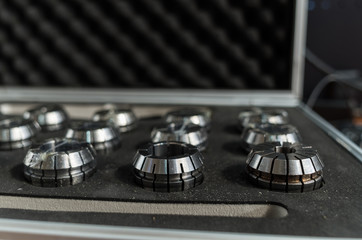 Collets set of different sizes and diameters for milling cutters and drills in a сase.
